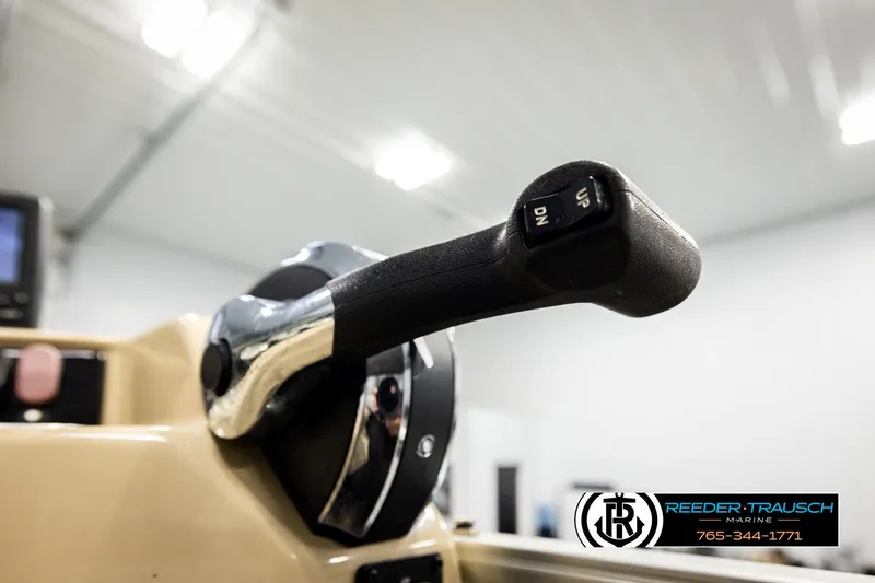 Slide: The Image of Close-up of 2015 Lowe SS 210 boat throttle lever in a marine showroom. - 32