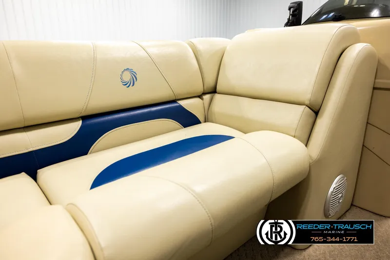 Slide: The Image of Luxurious beige and blue seating in a 2015 Lowe SS 210 boat interior. - 34