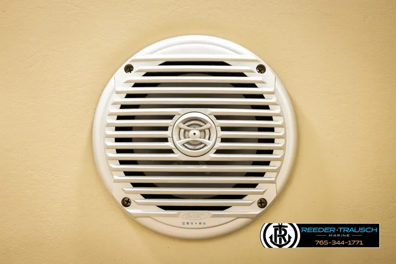Slide: The Image of White speaker grill on a 2015 Lowe SS 210 boat interior wall. - 36