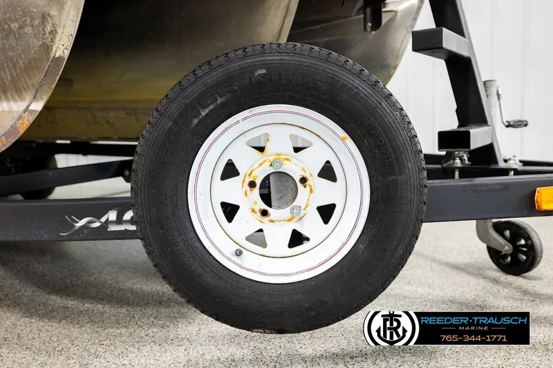 Slide: The Image of Trailer wheel of a 2015 Lowe SS 210 boat on display. - 44