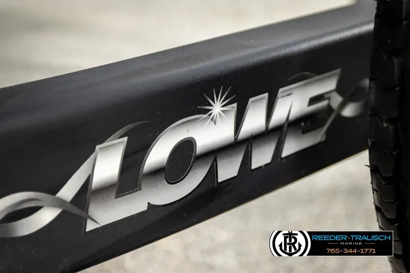 Slide: The Image of Close-up of 2015 Lowe SS 210 logo on a black surface. - 45