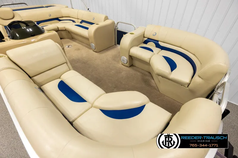 Slide: The Image of 2015 Lowe SS 210 pontoon boat interior with beige and blue seating, carpeted floor. - 9