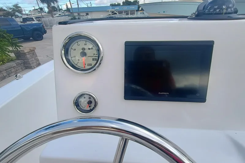 Slide: The Image of 2026 Robalo R160 Center Console dashboard with Garmin display and gauges. - 15