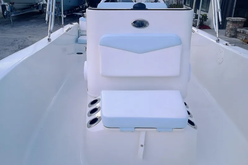 Slide: The Image of 2026 Robalo R160 Center Console boat interior with cushioned seating and cup holders. - 16
