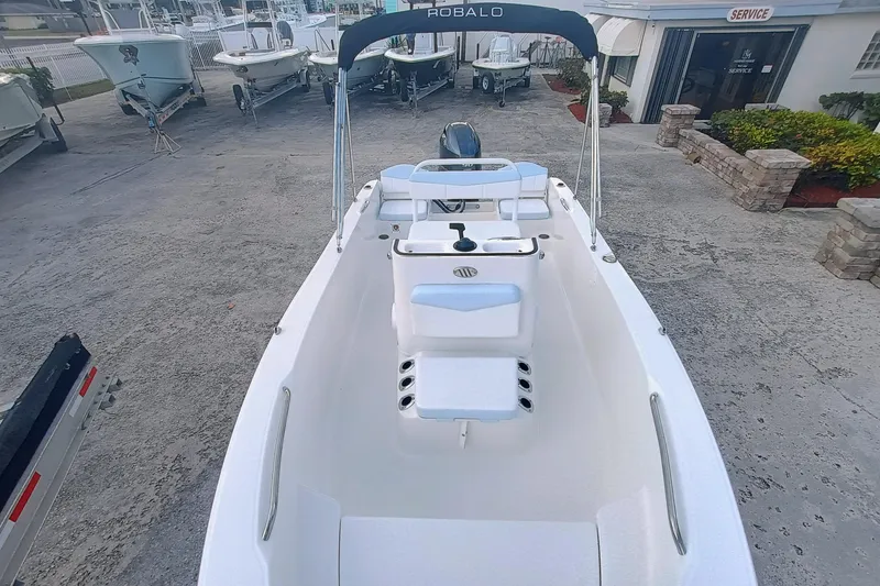 Slide: The Image of 2026 Robalo R160 Center Console boat in a dealership lot, showcasing sleek design. - 17