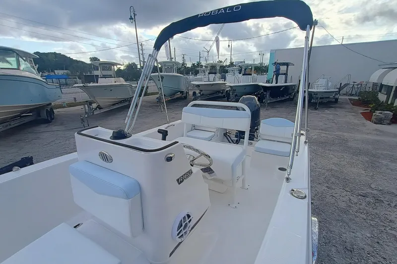 Slide: The Image of 2026 Robalo R160 Center Console boat in a marina setting, showcasing sleek design. - 18