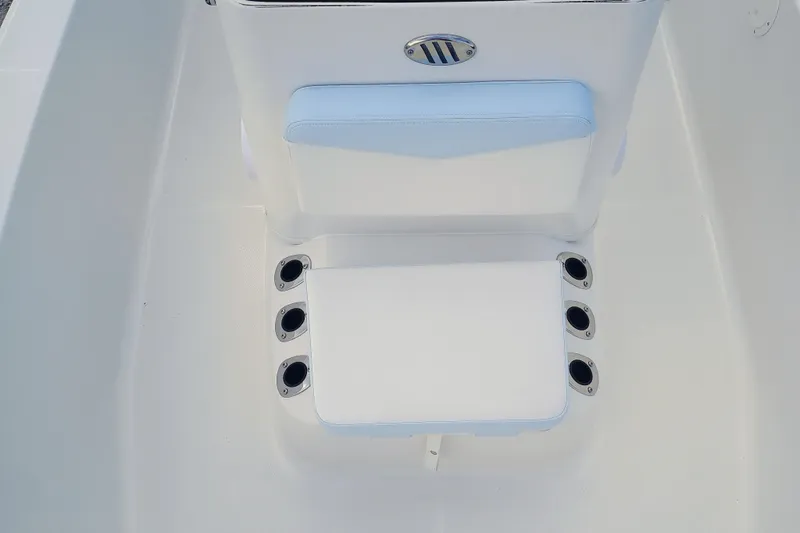 Slide: The Image of 2026 Robalo R160 Center Console boat seat with rod holders, white and blue design. - 19