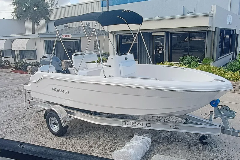 Slide: The Image of 2026 Robalo R160 Center Console boat on trailer outside dealership. - 20