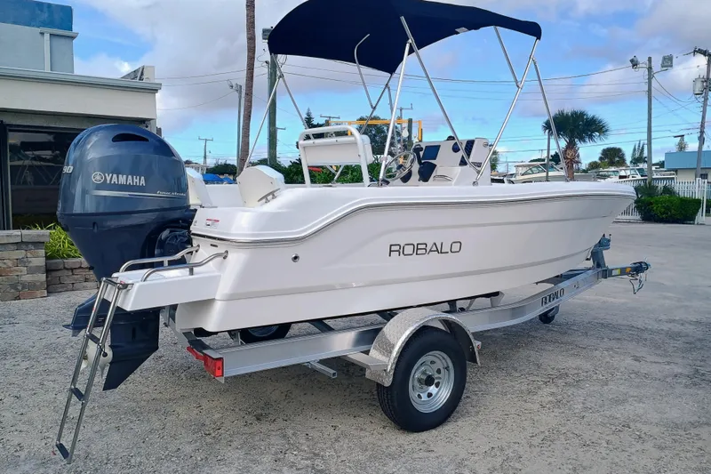 Slide: The Image of 2026 Robalo R160 Center Console boat with Yamaha engine on trailer. - 21