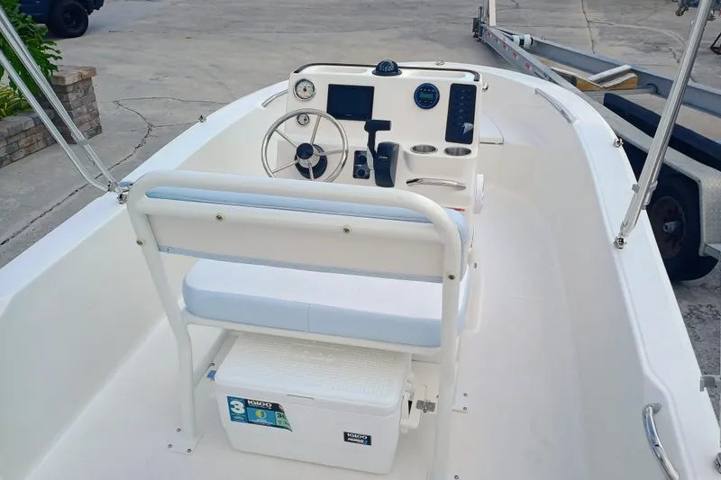 Slide: The Image of 2026 Robalo R160 Center Console boat interior with steering wheel and seating. - 9