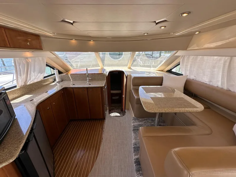 Slide: The Image of Luxurious interior of a 2007 Meridian 411 Sedan yacht with modern kitchen and dining area. - 29