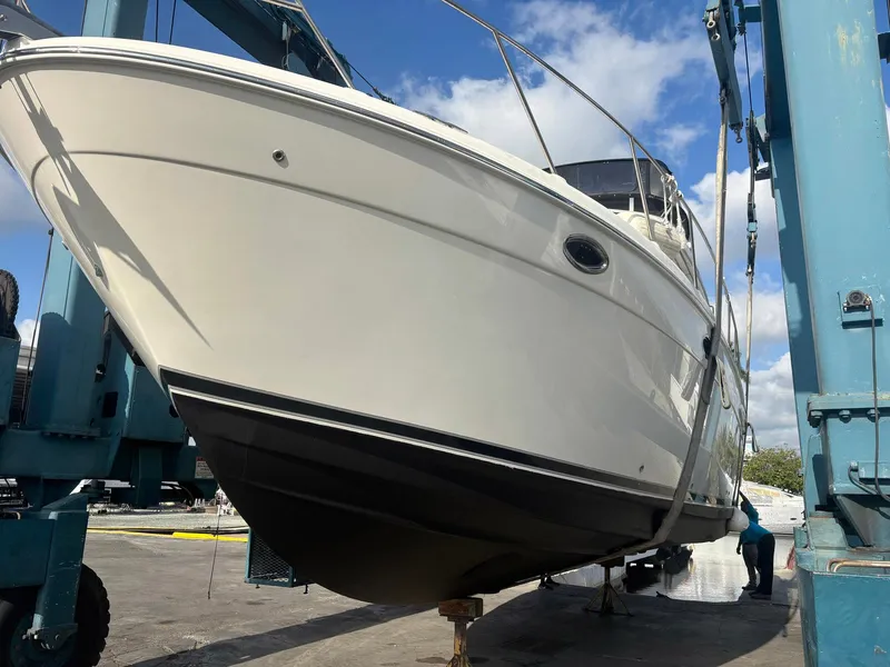 Slide: The Image of 2007 Meridian 411 Sedan yacht in dry dock, viewed from below, with blue sky background. - 5