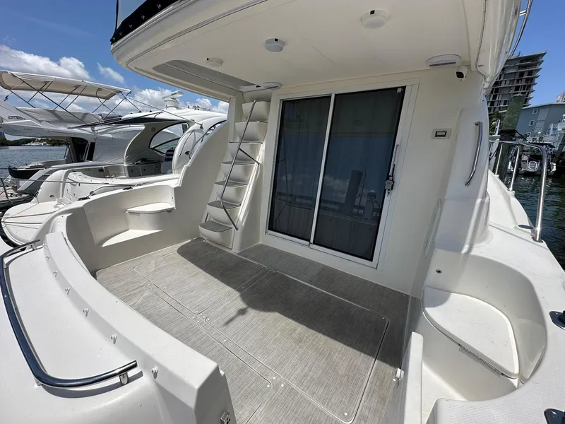 Slide: The Image of 2007 Meridian 411 Sedan yacht deck with seating and sliding door, docked at marina. - 7