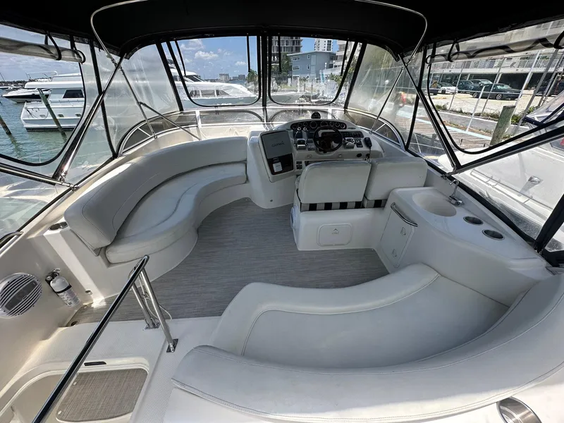 Slide: The Image of 2007 Meridian 411 Sedan interior with spacious seating and helm, docked at marina. - 9
