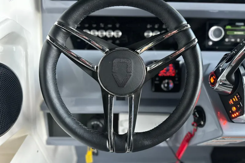 Slide: The Image of Steering wheel of 2025 Navan S-30 boat with modern dashboard controls. - 18