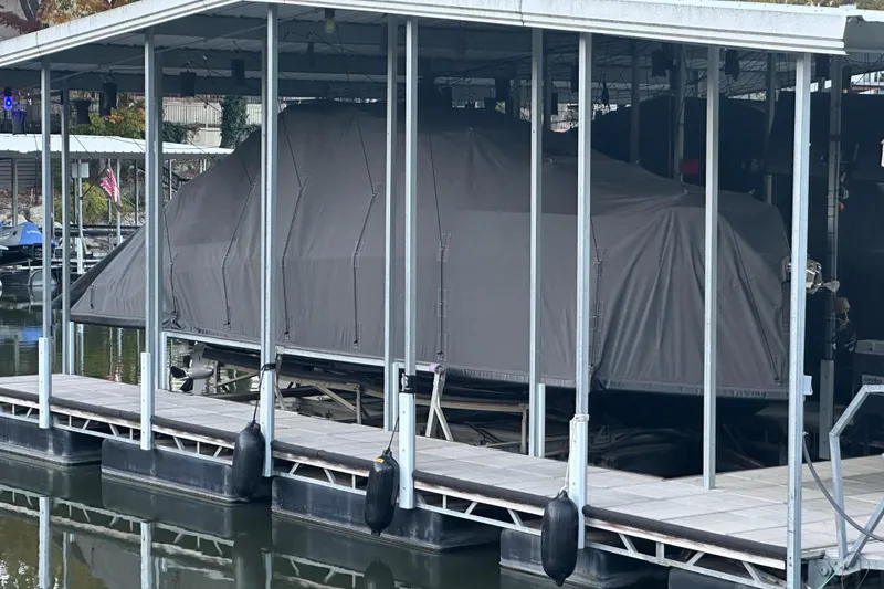 Slide: The Image of Covered 2025 Navan S-30 boat docked in a marina. - 21