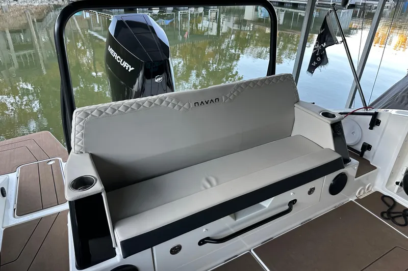 Slide: The Image of Navan S-30 boat interior with Mercury engine, featuring cushioned seating and cup holders, 2025 model. - 36