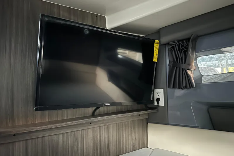 Slide: The Image of Flat-screen TV in 2025 Navan S-30 interior, next to a window with curtains. - 39
