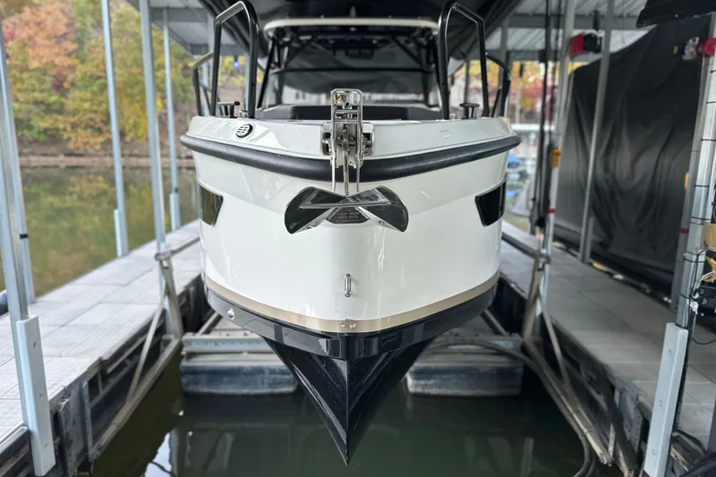 Slide: The Image of 2025 Navan S-30 boat docked, front view, in a covered marina setting. - 4