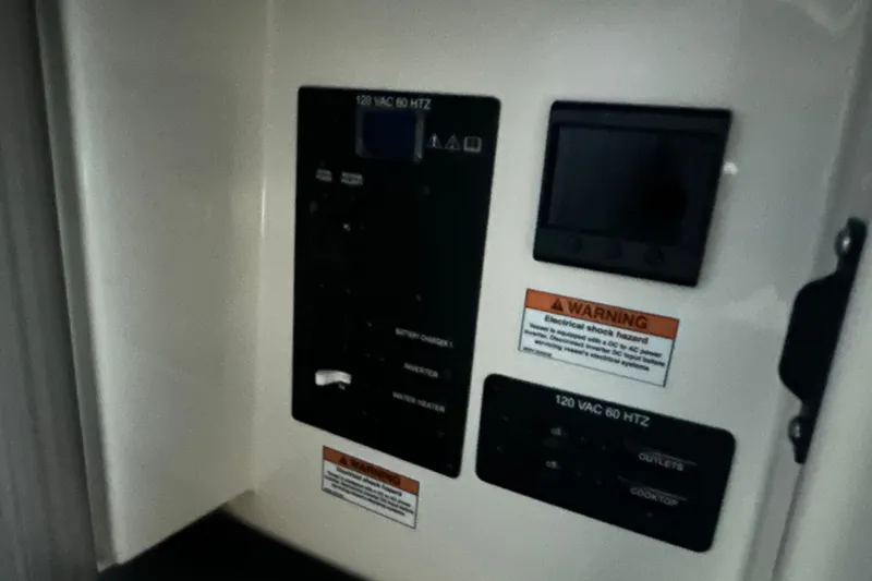 Slide: The Image of Electrical panel of Navan S-30, 2025 model, with warning labels and controls. - 41