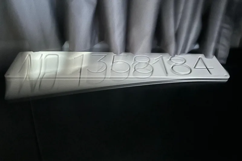 Slide: The Image of Navan S-30 2025 model number plate with NO 1358184, displayed on a dark surface. - 42