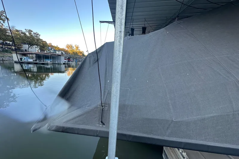 Slide: The Image of Covered Navan S-30 boat docked by a calm waterfront, 2025 model. - 46