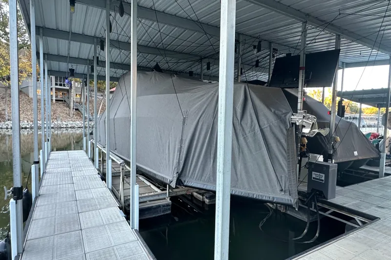 Slide: The Image of Covered Navan S-30 boat docked in a marina, 2025 model. - 47