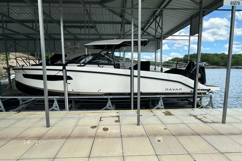 Slide: The Image of 2025 Navan S-30 boat docked under a metal canopy on a sunny day. - 49