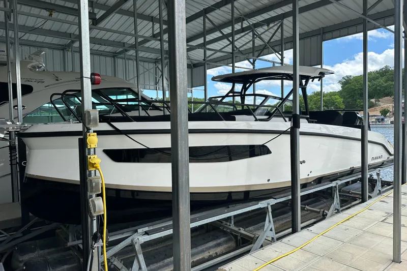 Slide: The Image of 2025 Navan S-30 boat docked in a covered marina, side view. - 50