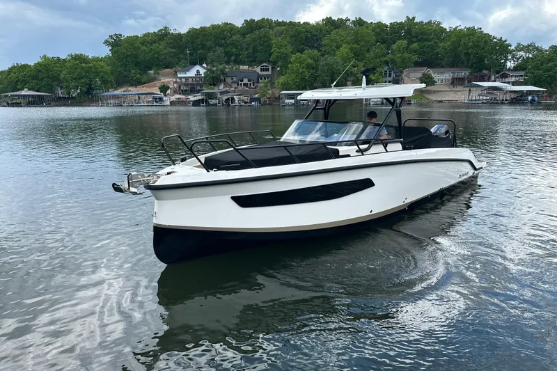 Slide: The Image of 2025 Navan S-30 boat cruising on a serene lake with lush green surroundings. - 52