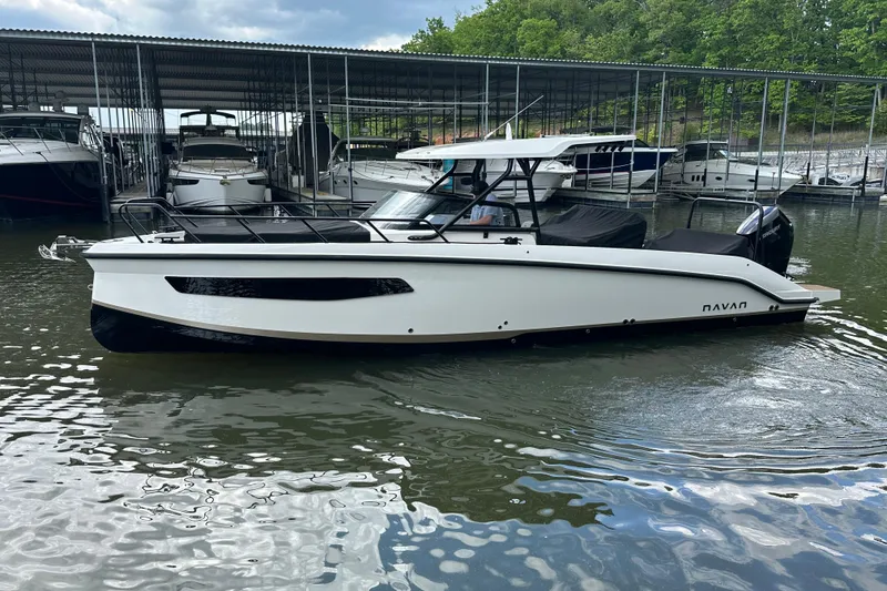 Slide: The Image of 2025 Navan S-30 boat docked at marina, surrounded by other vessels. - 53