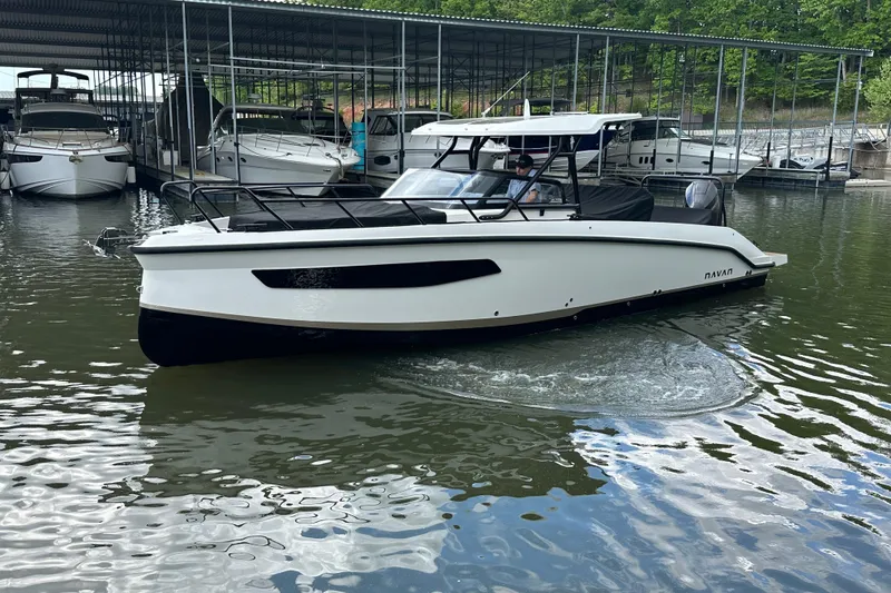 Slide: The Image of 2025 Navan S-30 boat docked in a marina, surrounded by other vessels. - 55