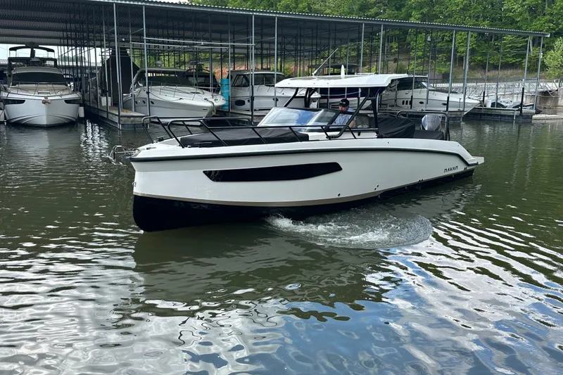 Slide: The Image of 2025 Navan S-30 boat docked in a marina, surrounded by other vessels. - 56