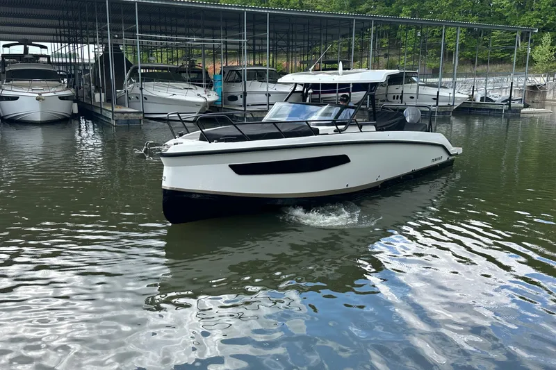 Slide: The Image of Navan S-30 2025 boat docked in a marina with other vessels. - 57
