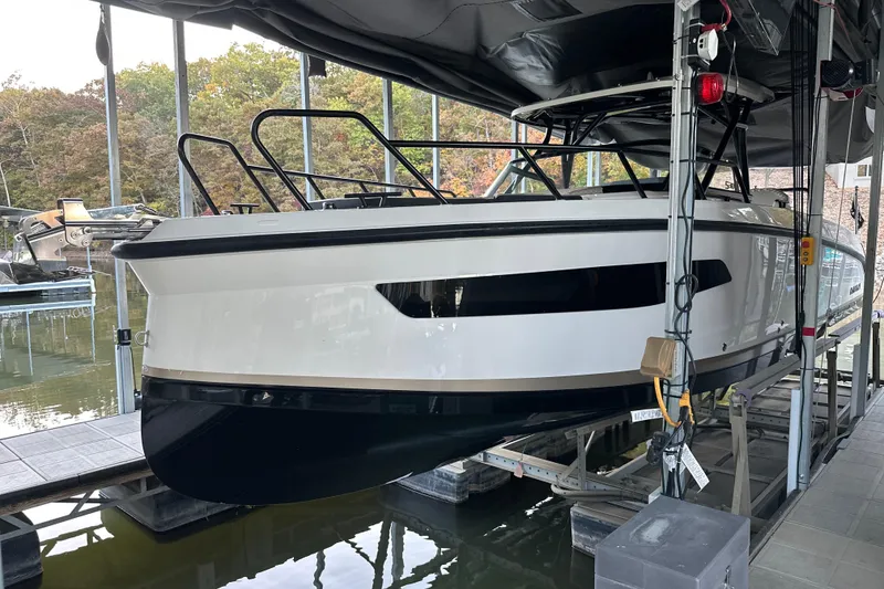 Slide: The Image of 2025 Navan S-30 boat docked in a marina, showcasing sleek design and modern features. - 6