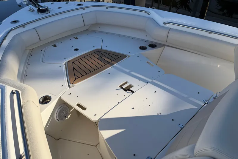 Slide: The Image of 2018 Boston Whaler 250 Outrage boat interior with white seating and storage compartments. - 10