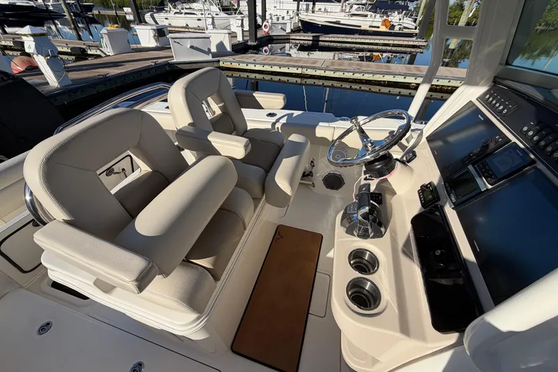 Slide: The Image of 2018 Boston Whaler 250 Outrage boat interior with helm and seating area. - 12