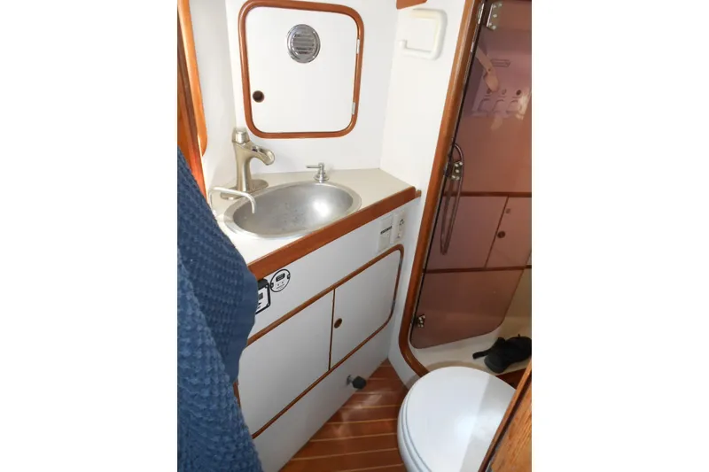 Slide: The Image of Compact bathroom in 1989 Norseman 447 yacht with sink, toilet, and shower. - 11
