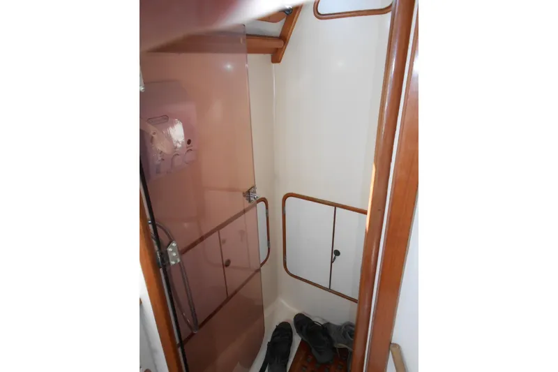 Slide: The Image of Interior of 1989 Norseman 447 sailboat with wooden trim and storage compartments. - 13