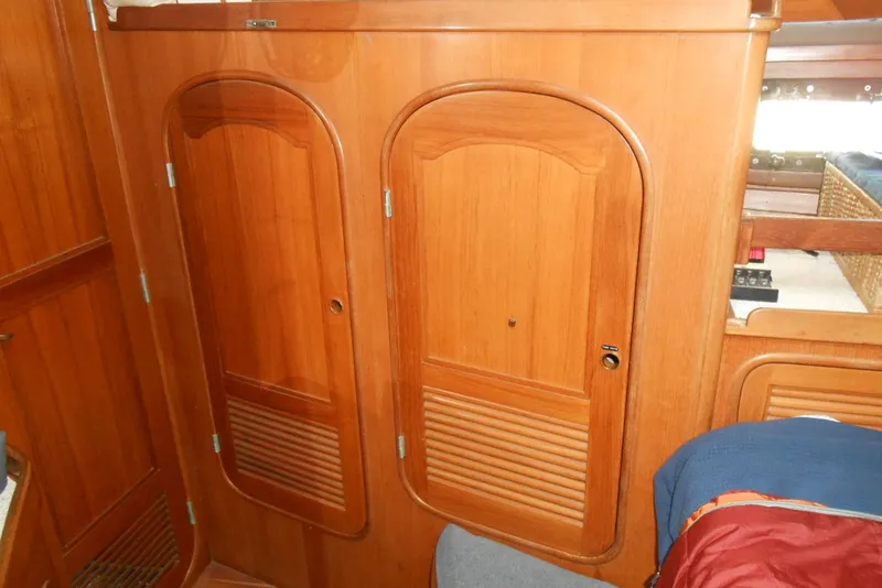 Slide: The Image of Wooden interior of 1989 Norseman 447 yacht with two arched cabinet doors. - 16