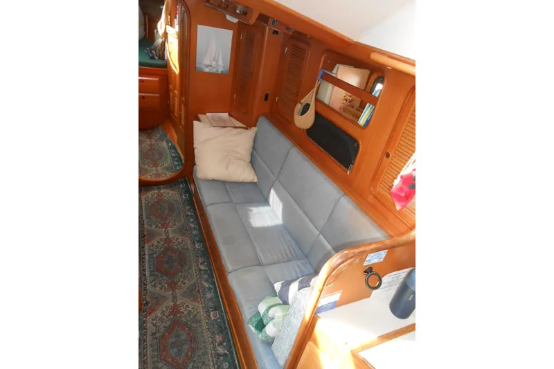 Slide: The Image of Cozy interior of 1989 Norseman 447 yacht with blue sofa and wooden accents. - 4