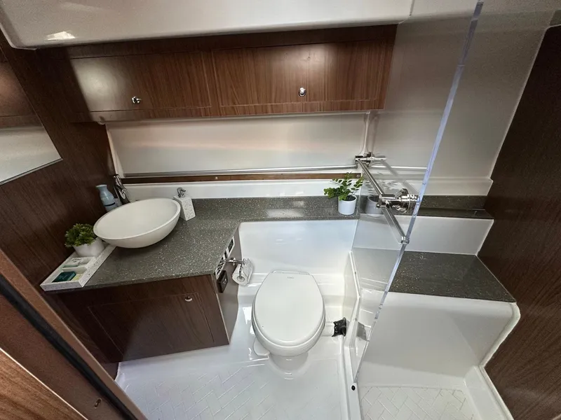 Slide: The Image of Luxurious bathroom in 2020 Four Winns Vista 355 Coupe yacht with modern fixtures and wood accents. - 10