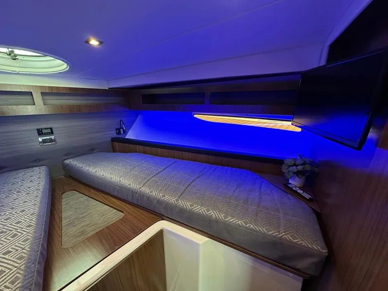 Slide: The Image of 2020 Four Winns Vista 355 Coupe cabin with modern lighting and sleek interior design. - 14