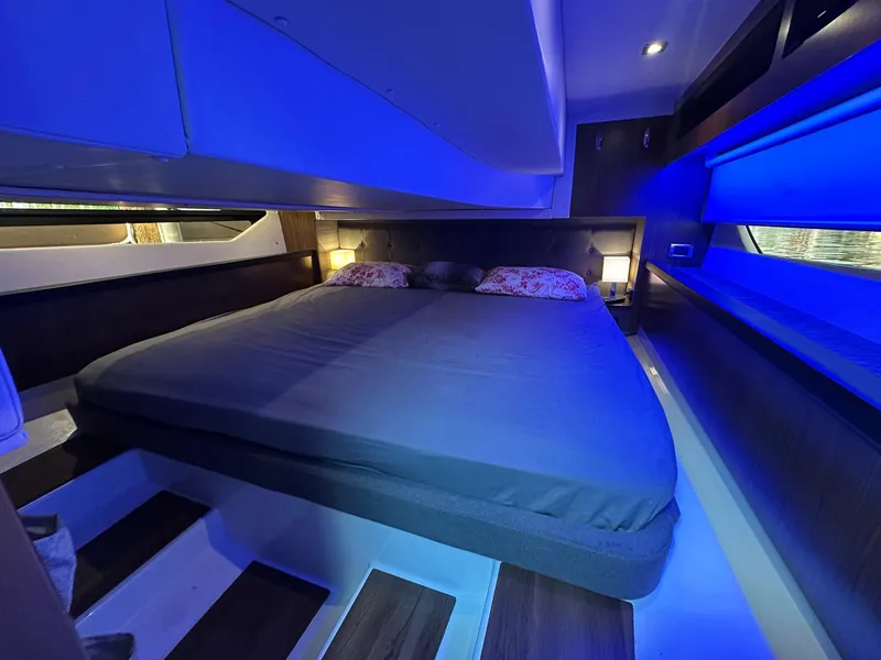 Slide: The Image of Luxurious cabin interior of 2020 Four Winns Vista 355 Coupe with ambient blue lighting. - 16