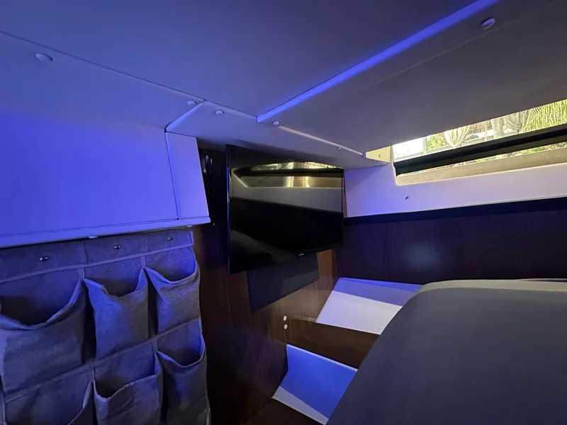 Slide: The Image of Interior of 2020 Four Winns Vista 355 Coupe with modern design and ambient lighting. - 17