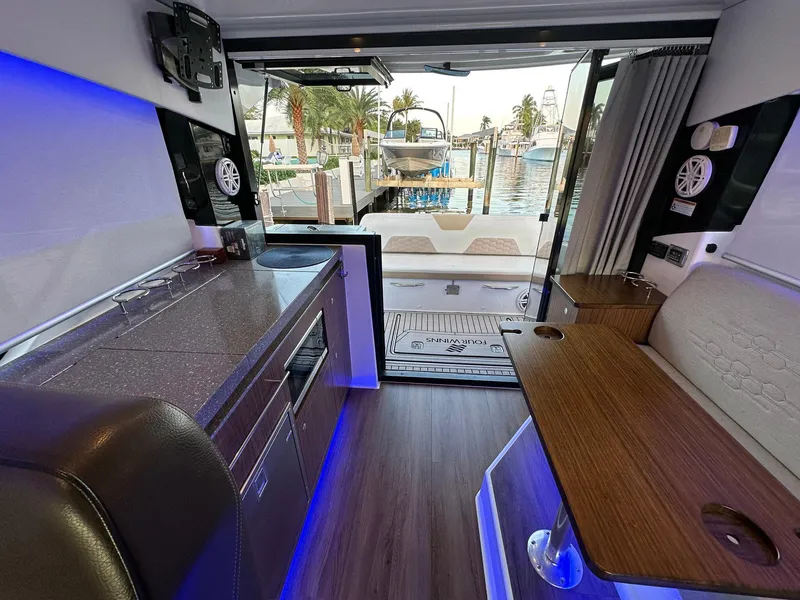 Slide: The Image of Interior of 2020 Four Winns Vista 355 Coupe yacht with modern kitchen and seating area. - 20