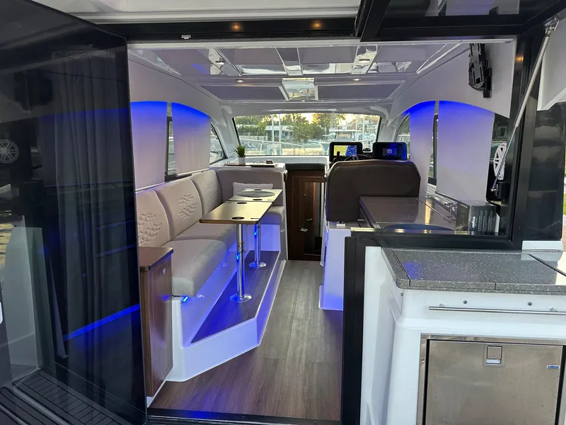 Slide: The Image of 2020 Four Winns Vista 355 Coupe interior with modern seating and ambient lighting. - 21