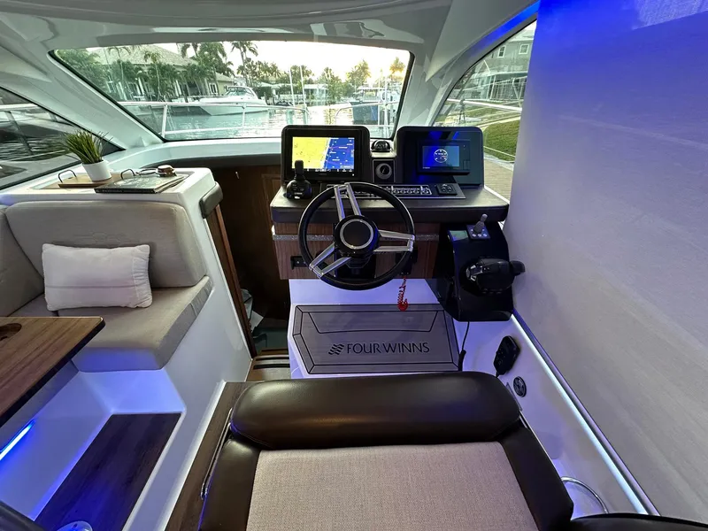 Slide: The Image of 2020 Four Winns Vista 355 Coupe interior with modern helm and navigation systems. - 27
