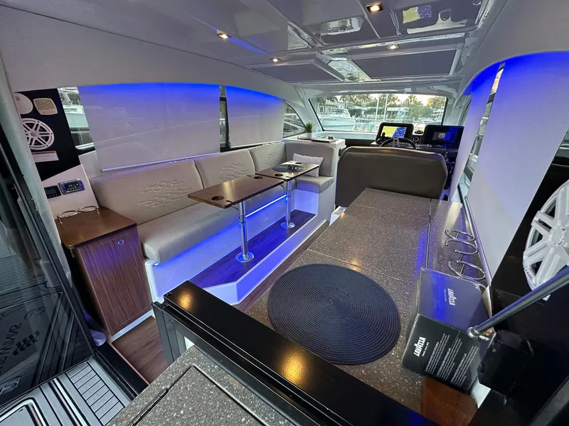 Slide: The Image of Interior of 2020 Four Winns Vista 355 Coupe with modern seating and ambient lighting. - 28