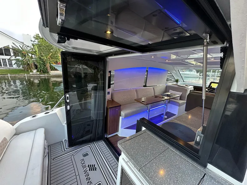 Slide: The Image of Interior view of 2020 Four Winns Vista 355 Coupe yacht with modern seating and ambient lighting. - 29